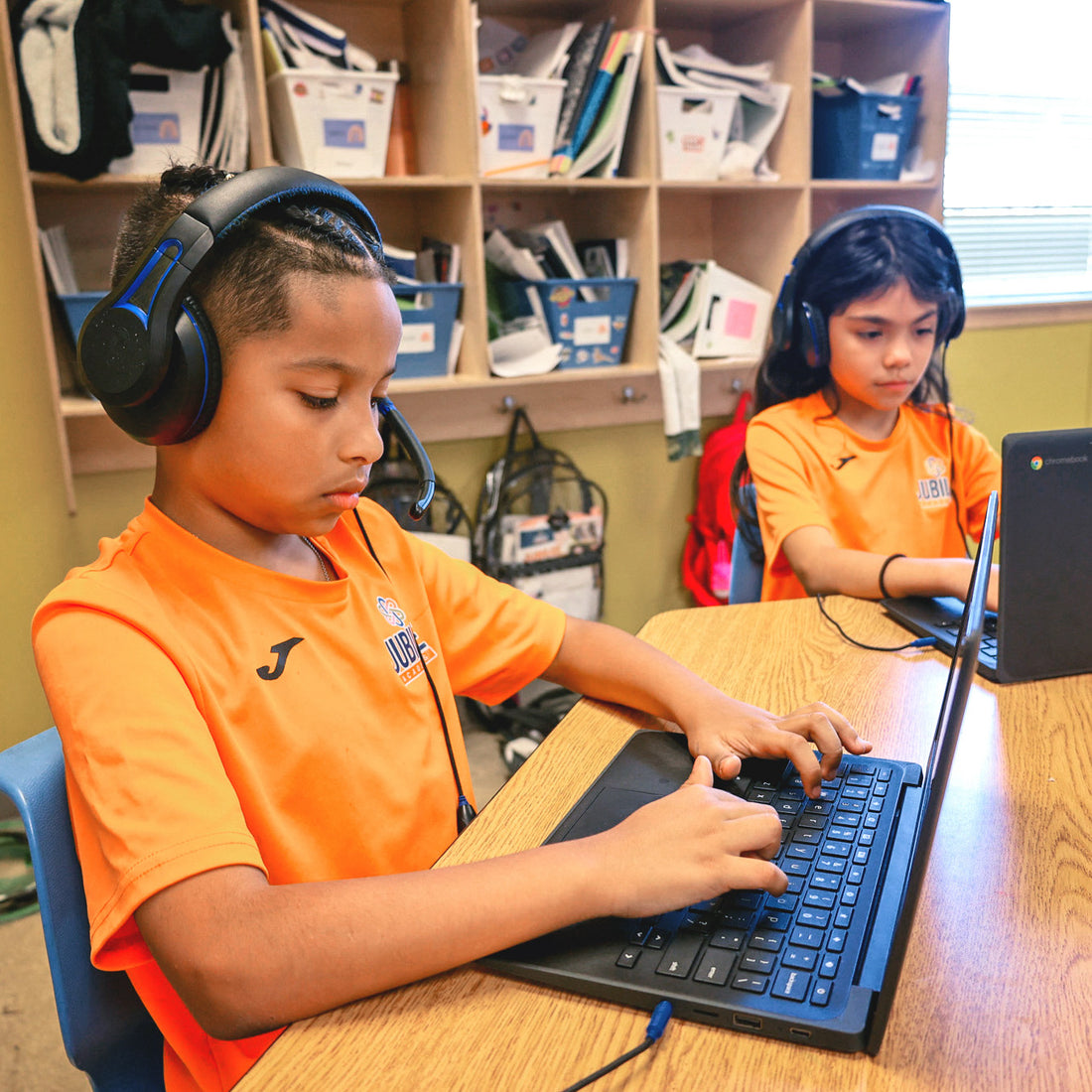 Students at Jubilee Academies using Chromebooks with TWT Audio classroom headsets