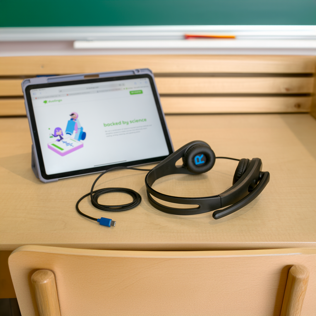An iPad on a study table with an ergo headset featuring a USB-C connection.