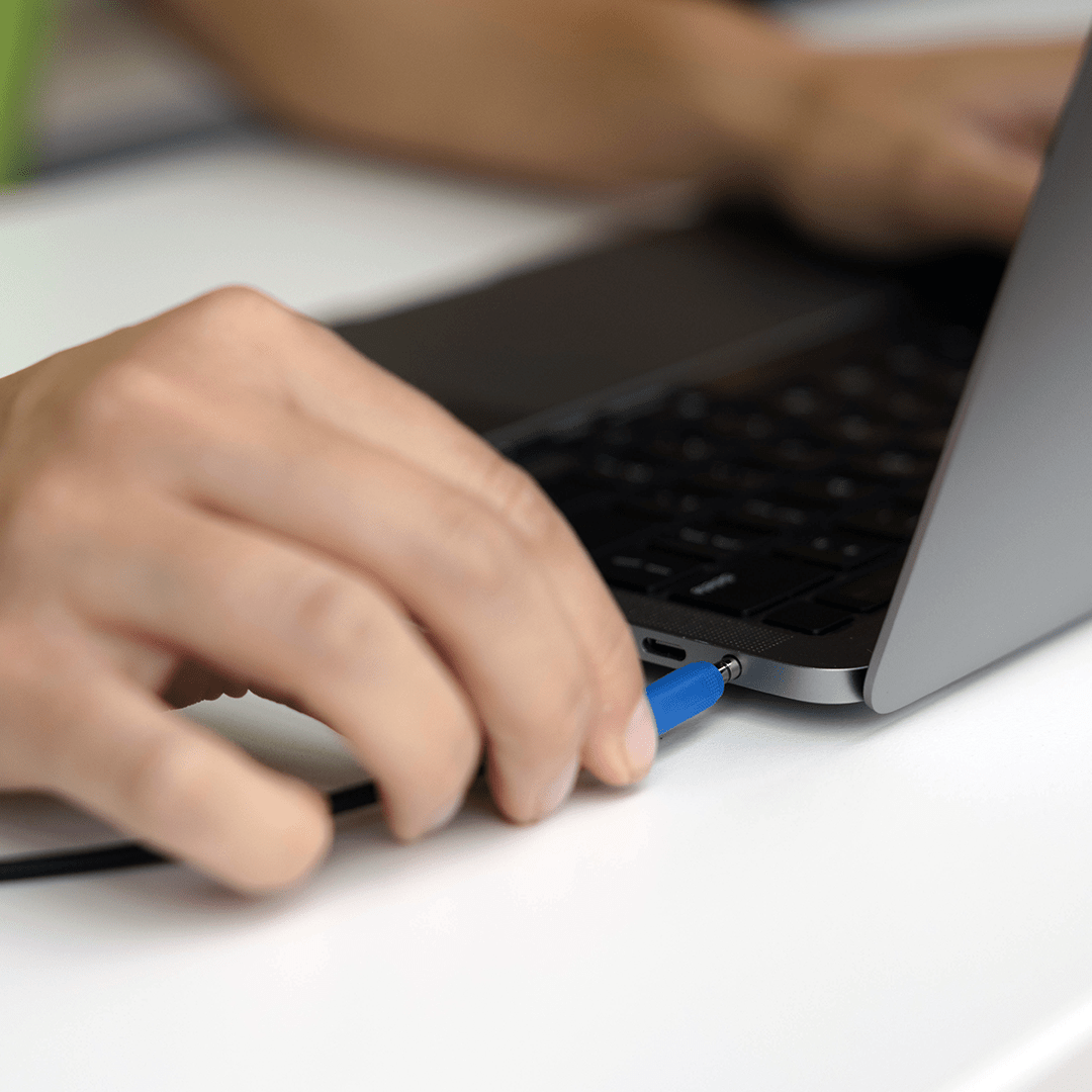 A student at a laptop using wired headphones, highlighting their reliable connection for focused study and audio clarity.